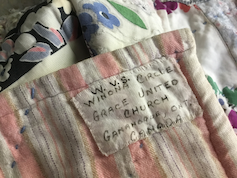 A close up of a quilt tag that reads