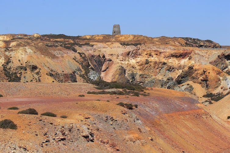 A quarried landscape of brown and orange earth.